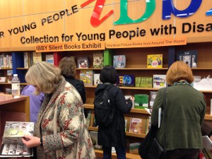 People peruse the books on display at the launch of the Silent Books Exhibit in Toronto. Photo courtesy Meghan Howe.